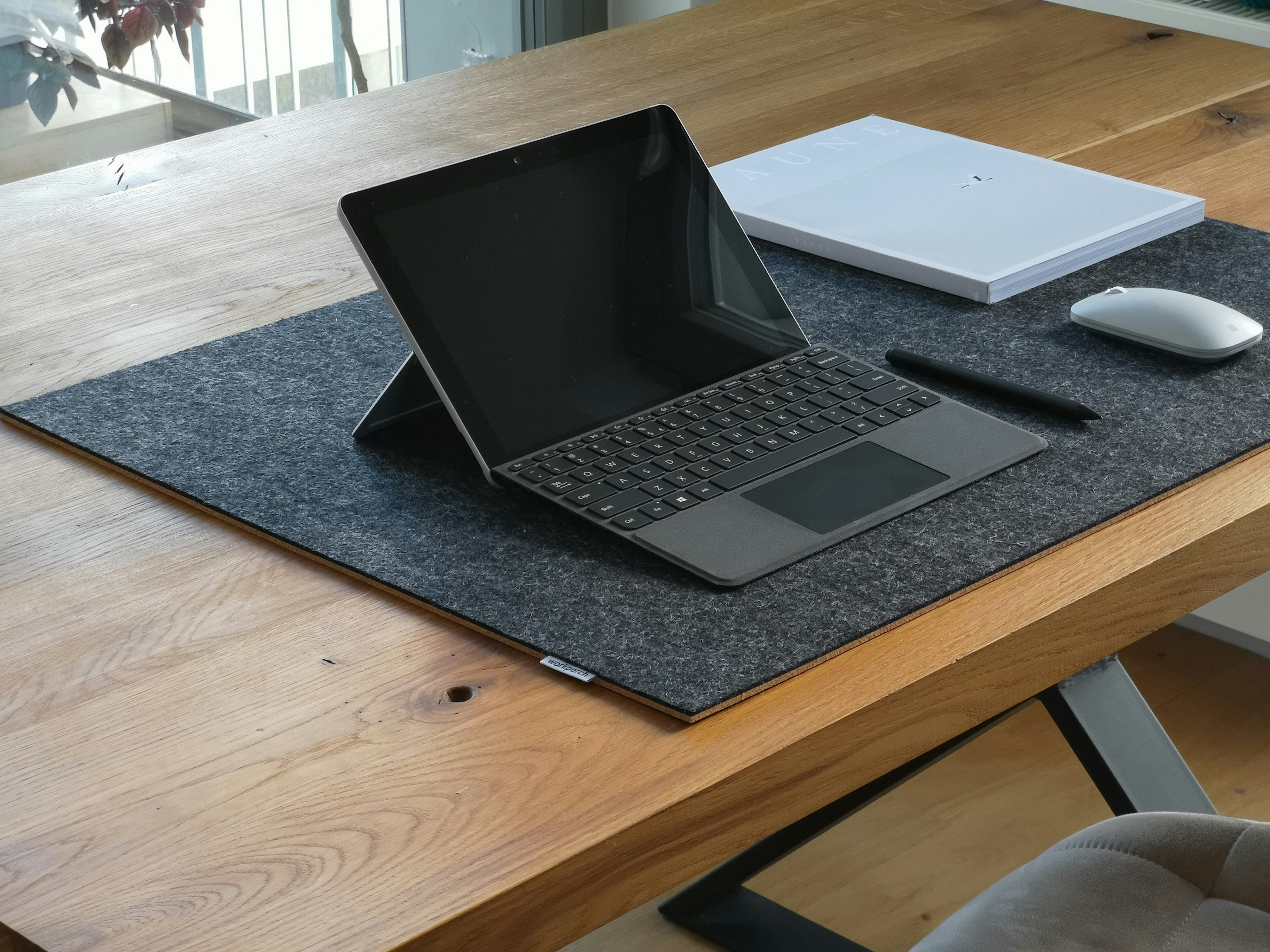 black and silver laptop computer on brown wooden table
